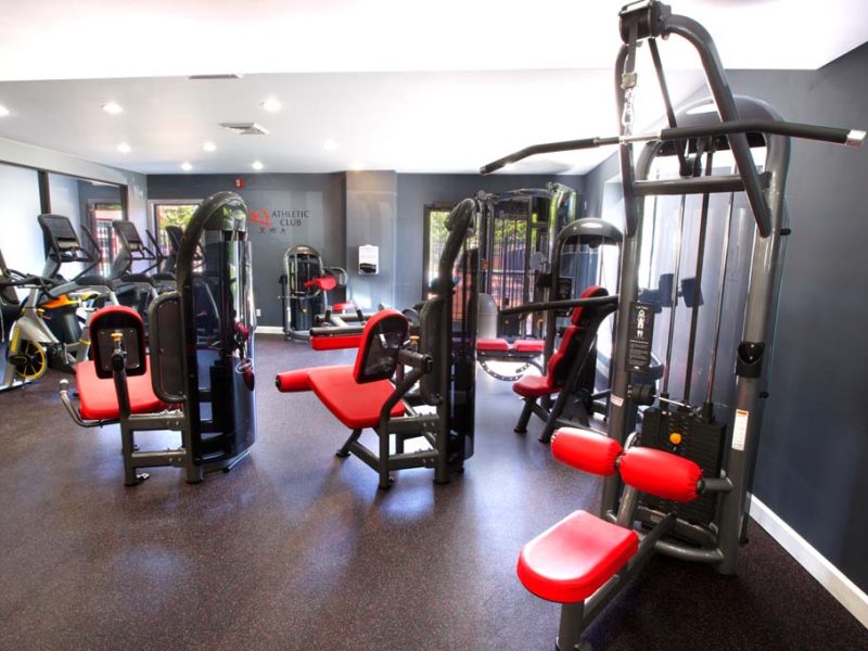 This image shows an expansive view of the fitness gym equipment featuring the yoga and spin studio with an indoor cycling mirror that was ideal for flexibility and strength exercise.